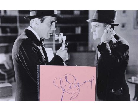 A red autograph album containing over 50 autographs of world entertainment stars on photographs, letters, cheques and USA fil