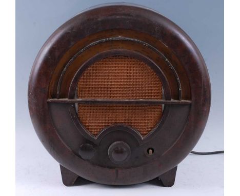 An Ekco A.C. 76 bakelite case radio of circular form with woven grill and plastic coated scales, designed by Wells Coates, ci