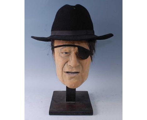 A life sized painted plaster model head of John Wayne as U.S. Marshall Rooster Cogburn from the 1969 film True Grit, with eye