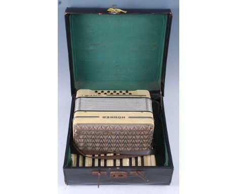 A Hohner Imperial I accordion, in faux pearl case with twelve buttons, in a leather outer case.