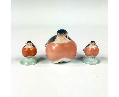 One bigger figurine with glossy finish. Modeled as a robin sitting. Grey and dusty rose coloring. Two smaller precious hand p