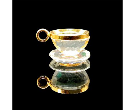 A clear faceted teacup with gold metal accent. This item has its original box: 3.5"L x 2.25"W x 1.25"H. Artist: Anton Popping