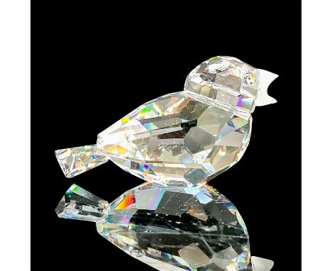 A clear faceted bird with tawny eyes and frosted beak. Swarovski mark. This item has its original box: 3.25"W x 2.5"H. Artist