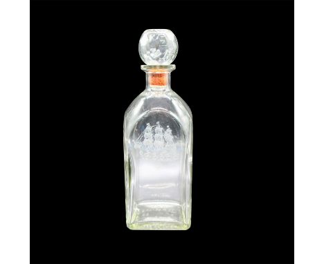 Clear glass bottle with prismed stopper, has etched sailing ship and compass on front of bottle. Armstrong imprint. Dimension