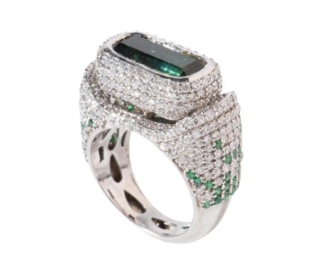 This men's statement ring exudes opulence with its bold emerald cut tourmaline, highlighted by gem quality round brilliant cu