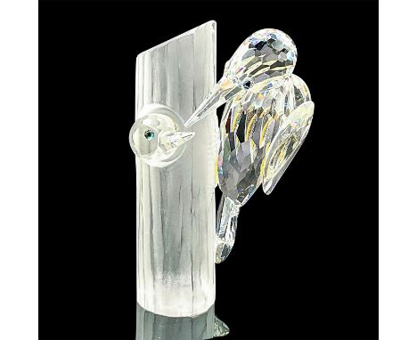Brilliant cut crystal figure of two woodpeckers, one inside of a tree trunk, one on the outside. The tree trunk is satin crys