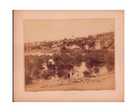 Captured in image are two gentlemen standing on the shore with vintage camera equipment between them. Taken on the most impor