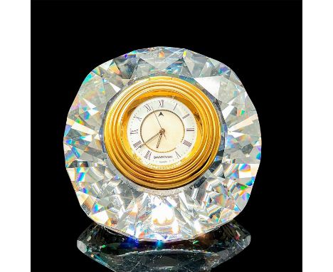 Gorgeous, battery operated desk clock consisting of a faceted and linear cut crystal base with sixteen panels encircling its 