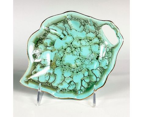 Turquoise toned with lustre finish &amp; branch patterning. Brass accent around rim.Cutout in piece allows for easy hanging. 