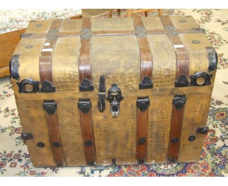 A metal wooden-bound travelling trunk covered with simulated reptile skin, 82cm wide, 59.5cm high.