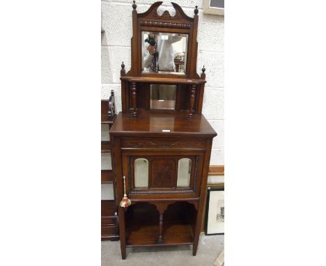 An Edwardian mahogany side cabinet, the mirrored back and single shelf on turned supports, above a single door and tapering l