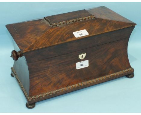 A George IV mahogany sarcophagus-shaped tea caddy fitted with two canisters and a cut glass mixing bowl with turned knob carr