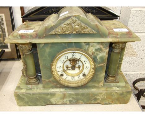 An early-20th century green marble mantel clock of architectural design with two columns, the movement stamped 'Ansonia Clock