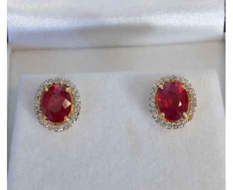 A Pair of Yellow Metal Oval Ruby and Diamond Cluster Ear Studs, rubies 4.56 ct, diamonds 0.37 ct (heat treated)