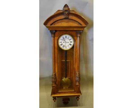 A Vienna Wall Clock, the enamel dial with Roman numerals and two train movement, the case with half Corinthian columns, 130 c