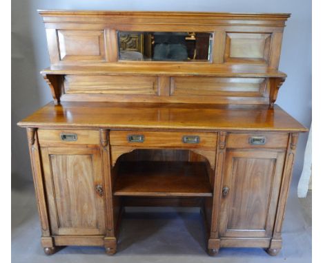 An Early 19th Century Mahogany Campaign Style Side Cabinet, the moulded back with a rectangular bevelled mirror, the lower se