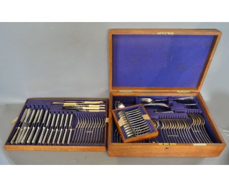 A Silver Plated Canteen of Cutlery, housed within an oak canteen cabinet, retailed by John R Buss & Sons, Manchester