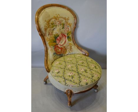 A Victorian Walnut Drawing Room Chair, with a tapestry back and seat raised upon carved cabriole legs with scroll feet