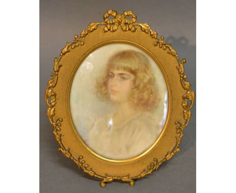 An Edwardian Portrait Miniature of a Girl within Oval Brass Frame, 11 x 9 cms
