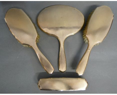 An Asprey London 9ct Gold Four Piece Dressing Table Set comprising hand mirror, two hand brushes and a clothes brush, 422.5 g