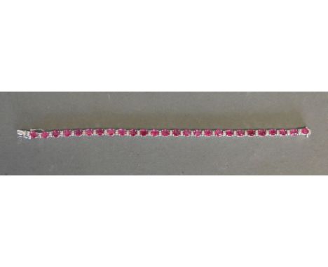 An 18ct White Gold Ruby and Diamond Line Bracelet, rubies 13.17 ct, diamonds 0.67 ct