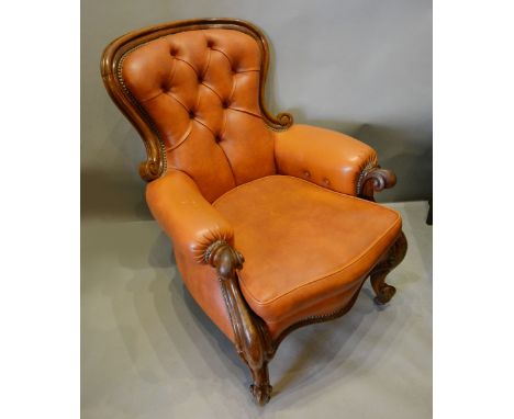 A Victorian Mahogany Club Chair, the shaped and button upholstered back above a serpentine seat raised upon cabriole legs wit