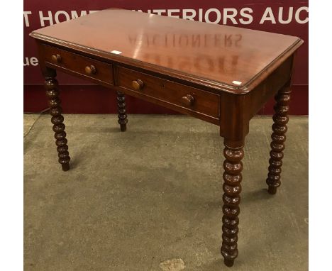 A Victorian mahogany bobbin turned two drawer writing table 