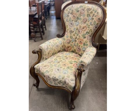 A Victorian carved mahogany and fabric upholstered armchair 