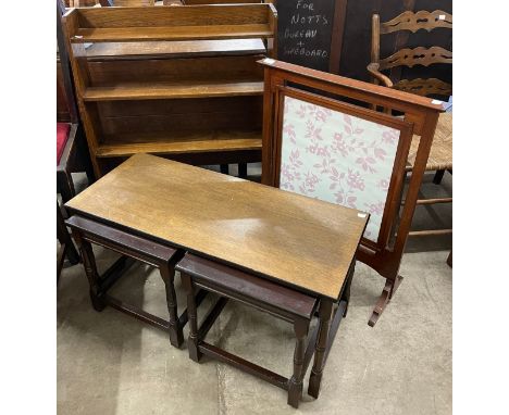 An oak nest of tables, an elm open bookcase and a mahogany firescreen