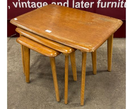 An Ercol style light oak nest of tables 