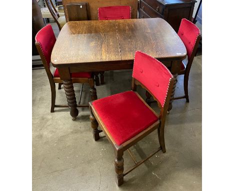 An early 20th Century oak bobbin turned extending dining table and four chairs 