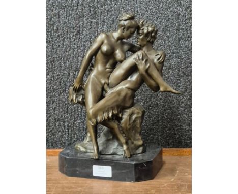 A bronze figure of an erotic female nude and faun, on black marble socle