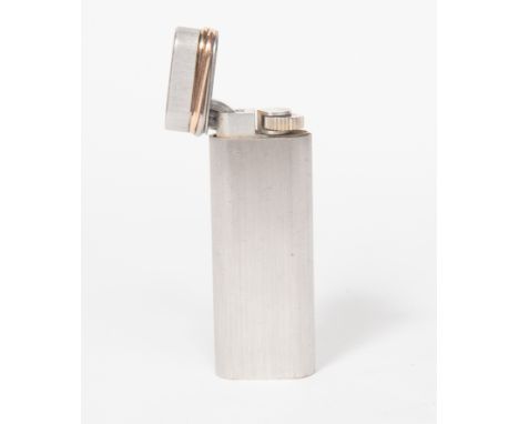 CARTIER lighter with gold plated detail to the edge of the hinged lid, rounded rectangular form, signed Cartier, length appro