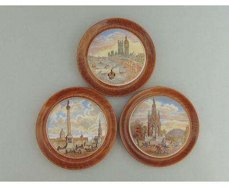 Three Staffordshire Prattware polychrome pot lids mounted in light wooden frames, titled 'Thames Embankment',  'Trafalgar  Sq