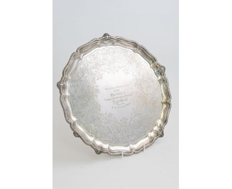 A Victorian silver salver, the pie crust rim chased with rocaille and ribboned foliage, the centre engraved with geometric pa