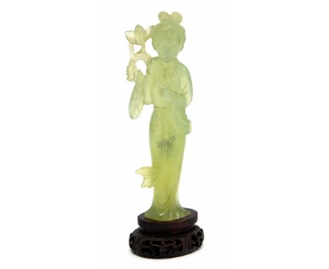 A Japanese carved jade figure of a standing Geisha holding a flower, 20th Century, height 12cm, wooden plinth Condition: good