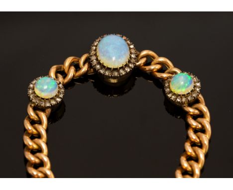 An opal and diamond 15ct gold bracelet, comprising three graduated white opals set to the front, with a blue/green play of co