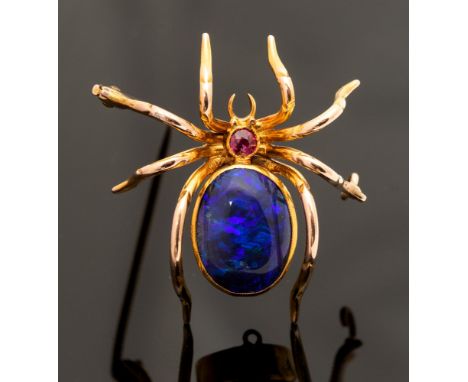 A black opal and ruby brooch, in the form of a spider, the body set with a black oval  opal measuring approximately 13mm x 12