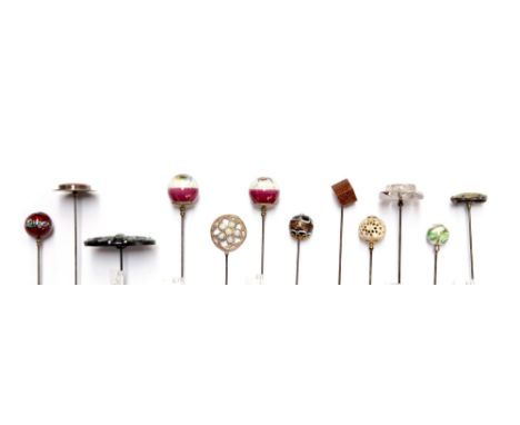 A collection of assorted hat pins, including a circular white metal and carnelian intaglio, depicting Artemis; two continenta