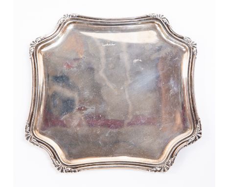 A George V plain silver salver shaped square with canted corners with stylized anthemions, on four stud feet, Atkin Brothers,