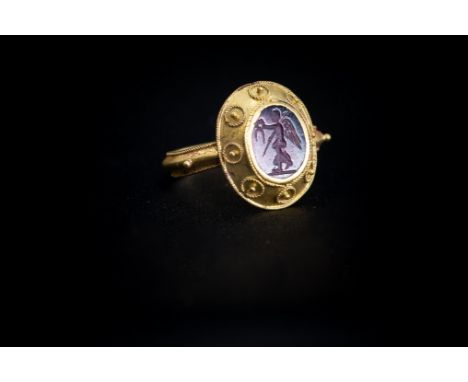 Roman (2nd-3rd century AD) A gold ring with ridged band, twisted rope pattern border to the edge, granule beads to the should