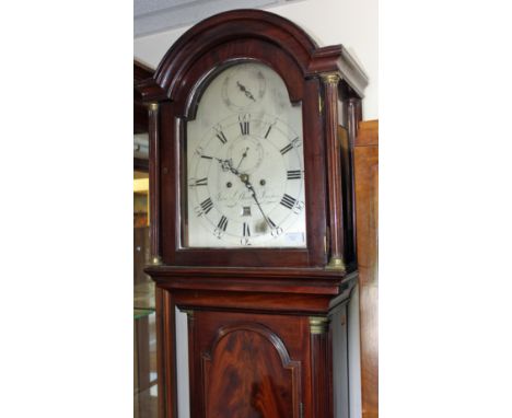 A George III mahogany eight longcase clock, with a silvered dial, indistinctly inscribed, the hood with an arched door, turne