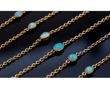 An Art Deco opal and  gold station chain necklace, comprising eleven optic set oval opals, blue/green play of colour, varying