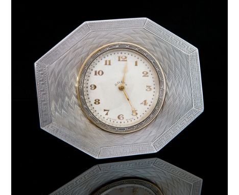 An Art Deco silver octagonal engine turned framed Swiss eight day movement timepiece, the frame with greek key pattern and ra