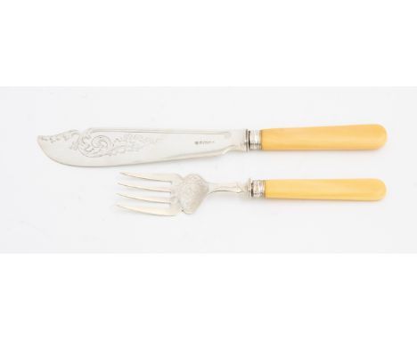 A pair of Victorian silver fish servers, engraved with scrolling foliage, ivory handles with reeded collars, Henry Wilkinson 