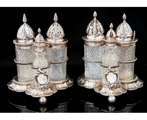 A pair of Victorian silver trefoil shaped cruet stands, the wavy sides engraved with foliate motifs beneath circular beaded b