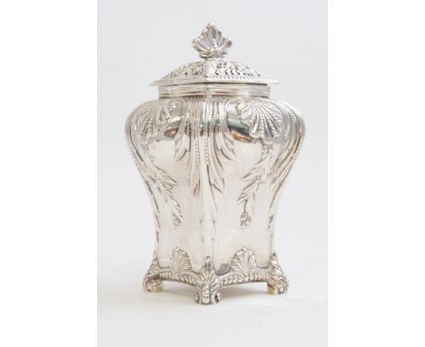 A Victorian silver caddy/pot pourri, ogee shaped on four anthemion feet, the body chased with rocaille and trailing foliage w