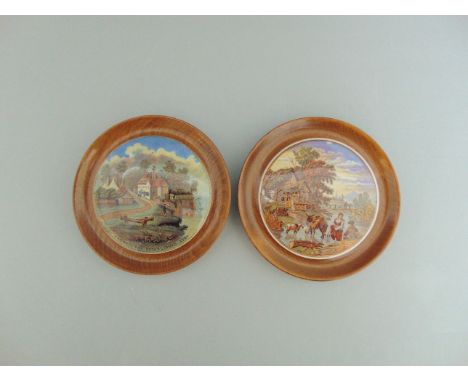 Two Staffordshire Prattware polychrome pot lids, mounted in light wooden frames titled  'Pegwell Bay' and  'Fording The Strea