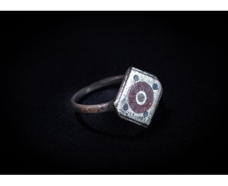 Romano-British (2nd-3rd century AD) Silver ring with plain band; square bezel with engraved circle to the centre with red, wh