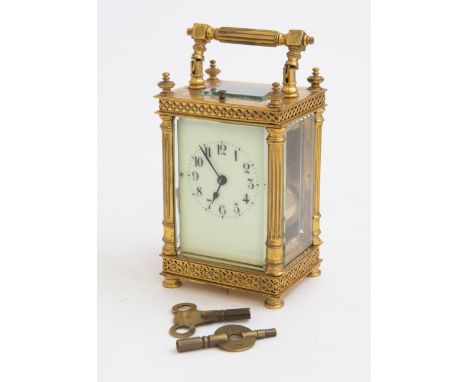 An early 20th Century French repeating carriage clock, brass corniche case, visible escapement window, Arabic enamel dial,the